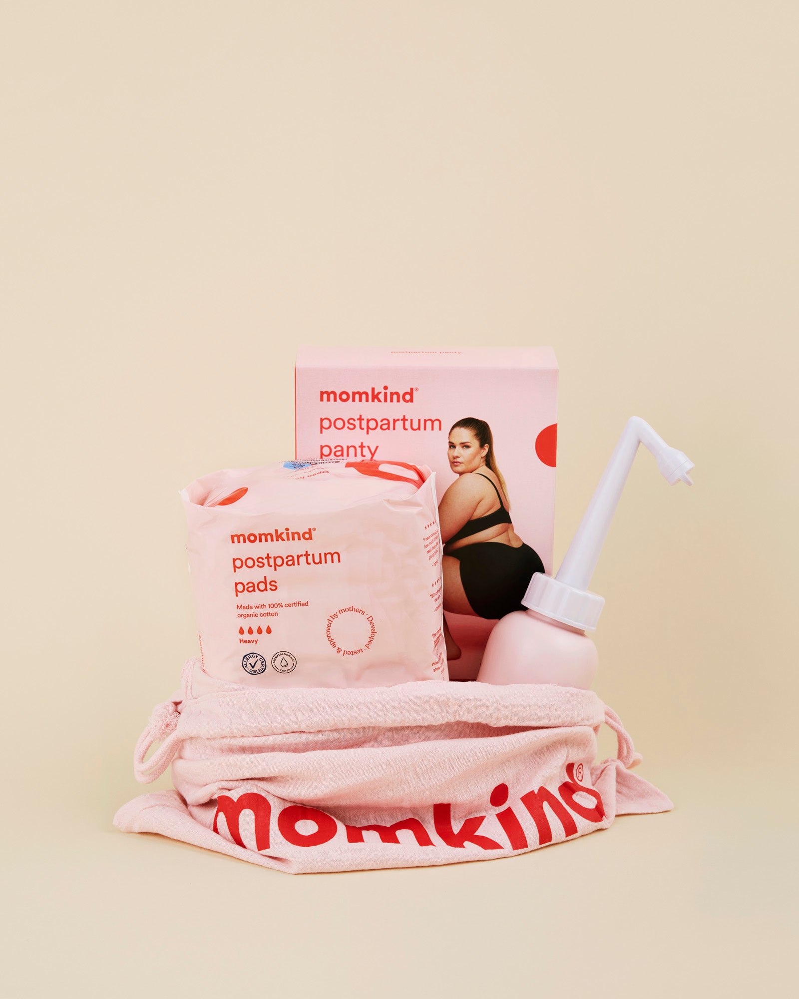 Momkind lille efterfoedselspakke. Posen indeholder efterfoedselsbind, efterfoedselstrusser og skylleflaske. 