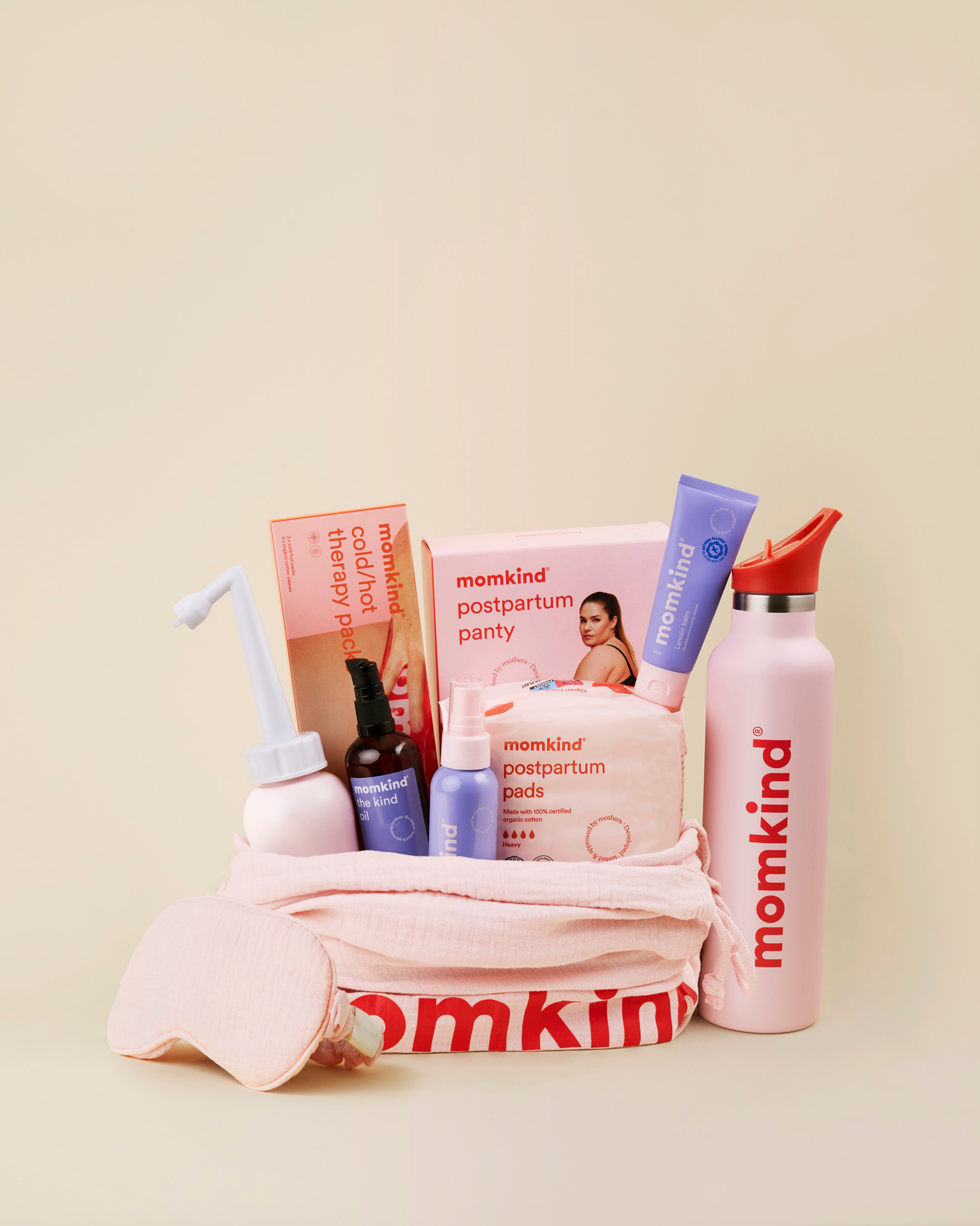 Momkind luksus efterfoedselspakke. Posen indeholder skylleflaske, postpartum serum mist, the kind oil, lanolin balm, efterfoedselsbind, koele/varme pose, efterfoedselstrusser og termo drikkedunk. 