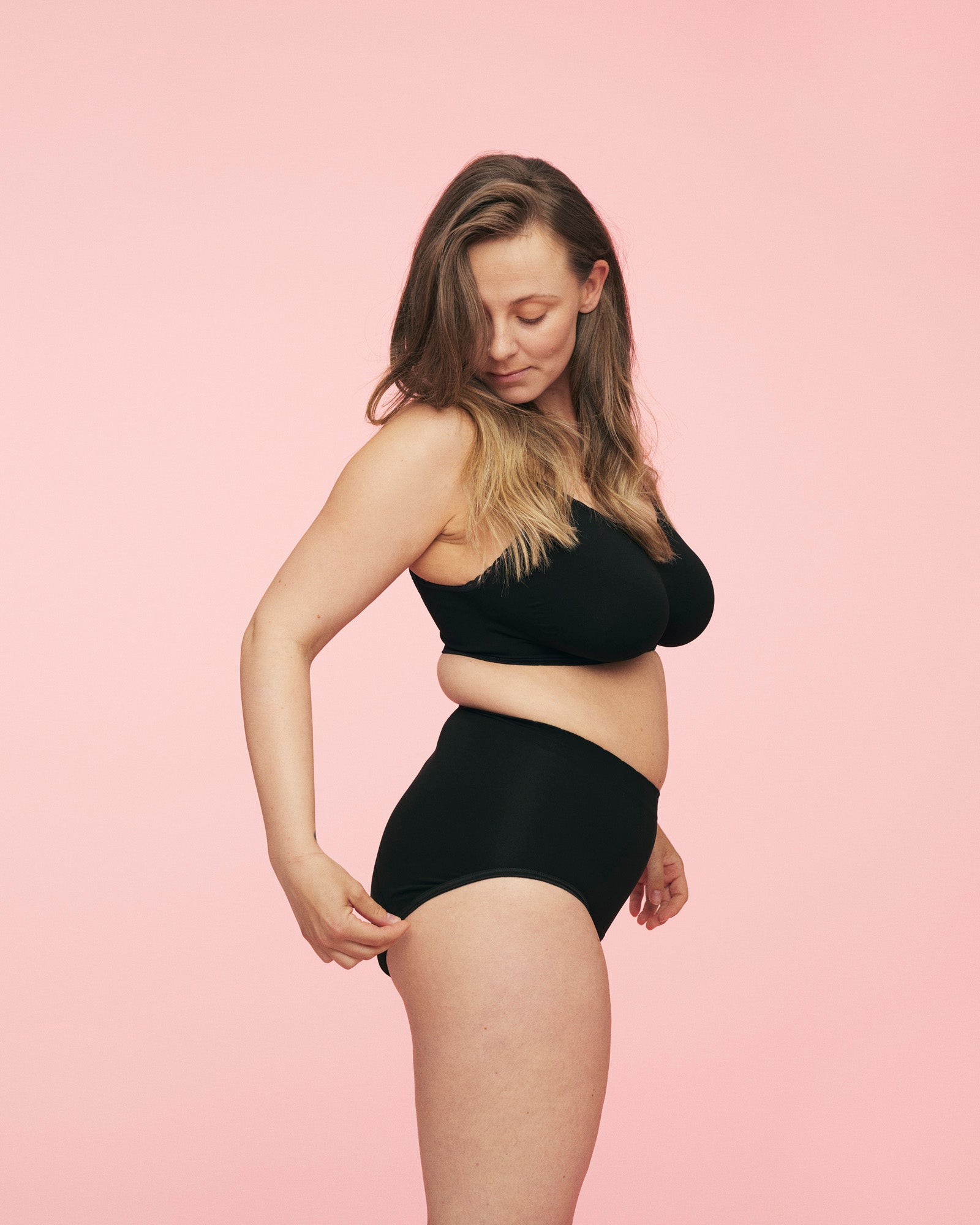 kvinde iført sort period brief menstruationstrusse og sort amme bh fra momkind