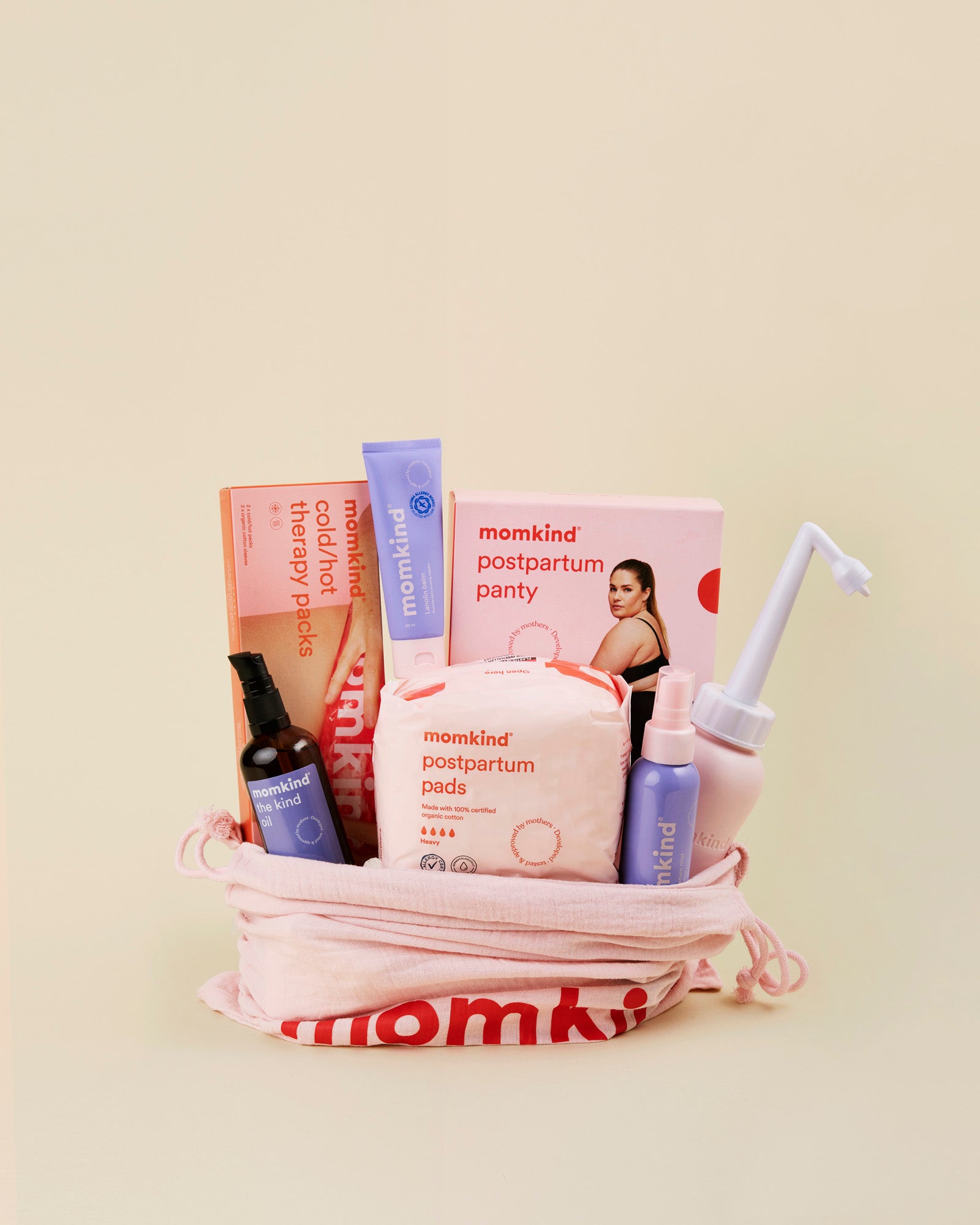 Momkind stor efterfoedselspakke. Posen indeholder skylleflaske, postpartum serum mist, the kind oil, lanolin balm, efterfoedselsbind, koele/varme pose, efterfoedselstrusser.